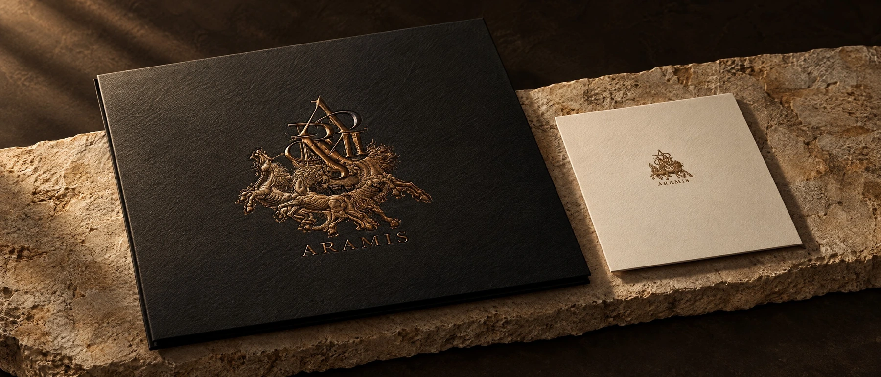The Aramis heraldic crest on dark stationery and cream correspondence.