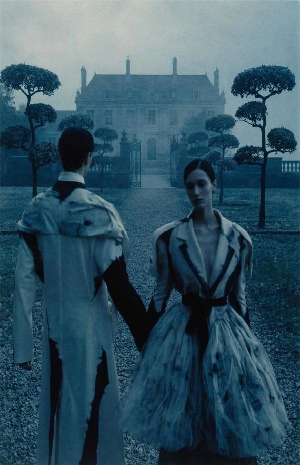 Fashion figures in a blue architectural world.