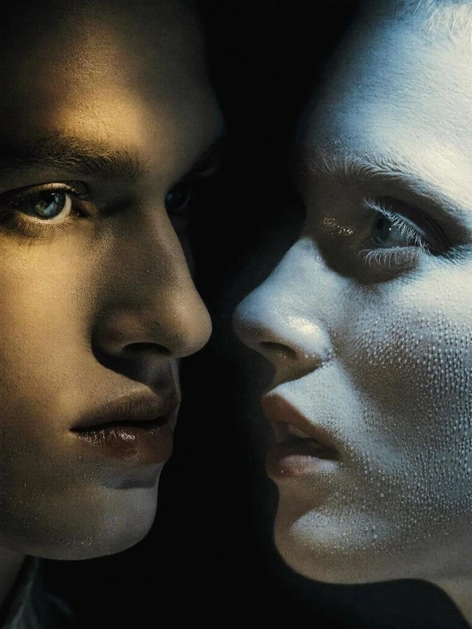Two faces in a close cinematic portrait.