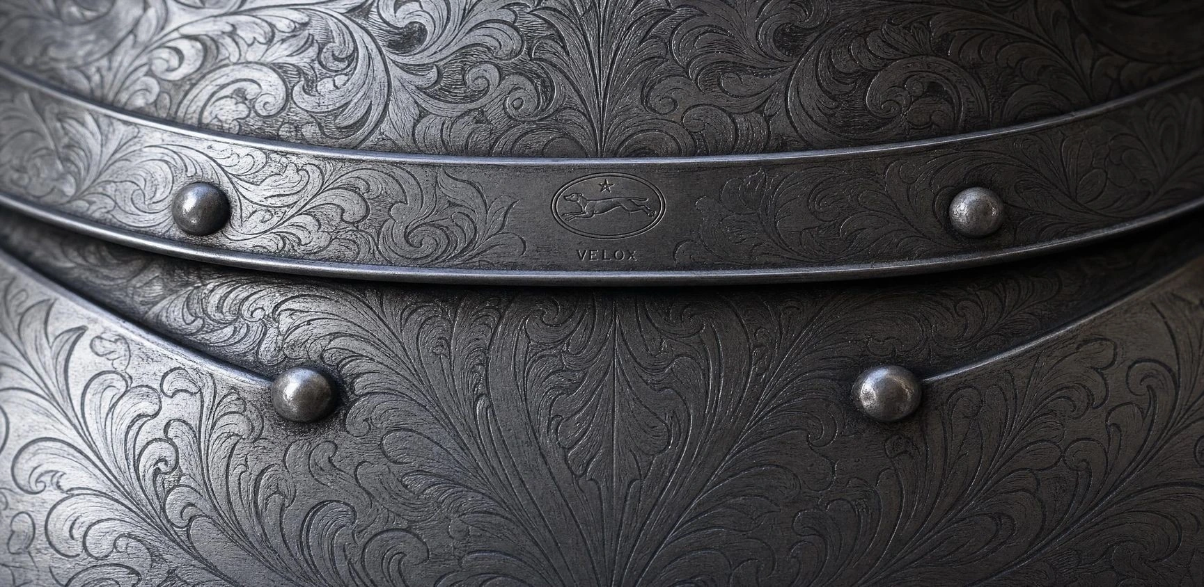 An engraved metal detail with ornamental linework.